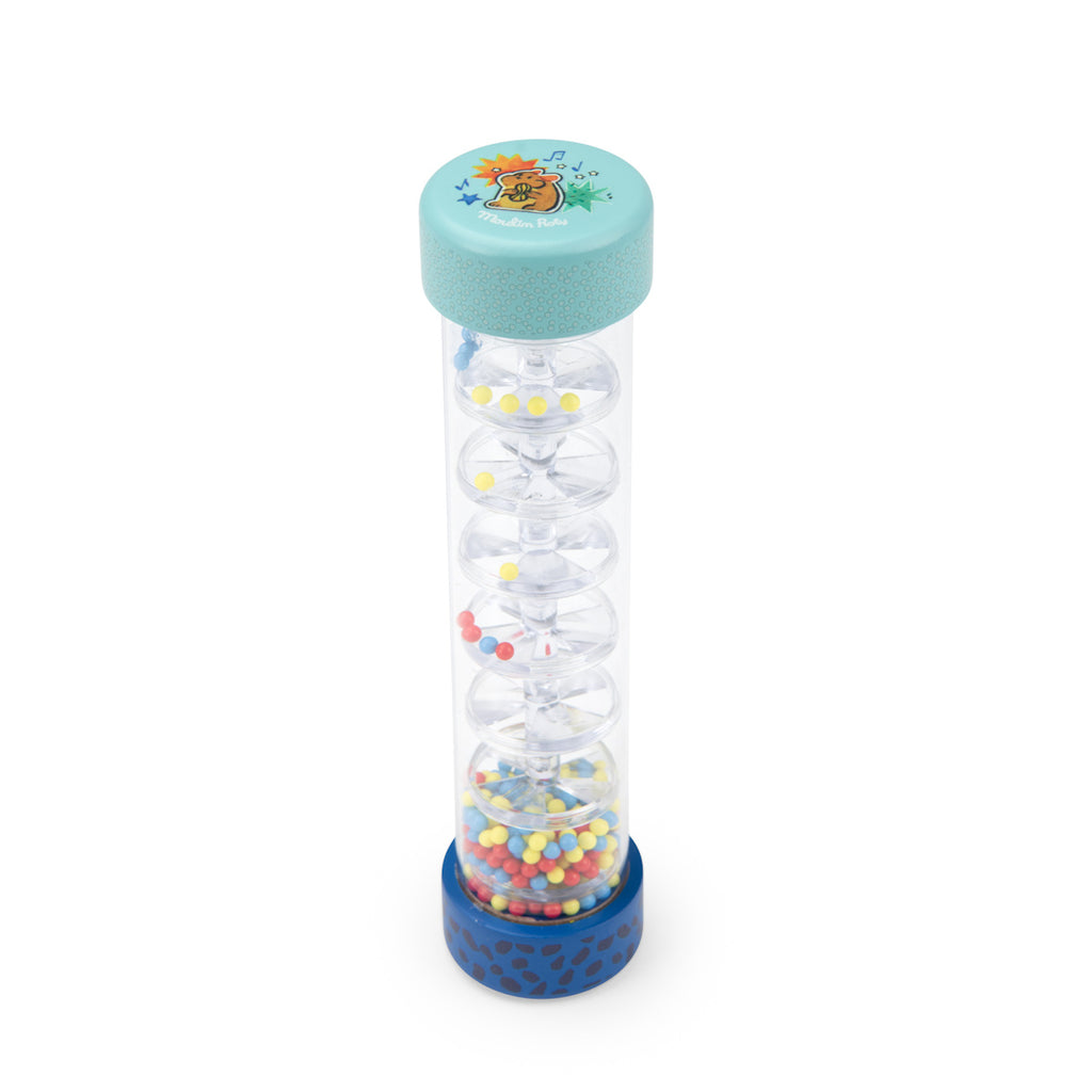 A clear plastic rain stick filled with colorful beads in red, yellow, and blue. It has a turquoise top with a playful design and a blue base.