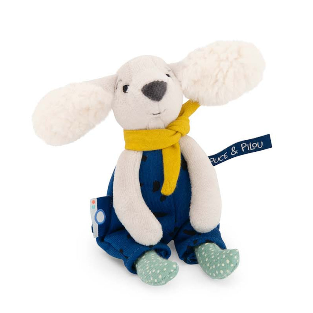 Plush toy dog with floppy ears, wearing a blue outfit with black spots, a yellow scarf, and light green socks. The toy looks playful and cute.