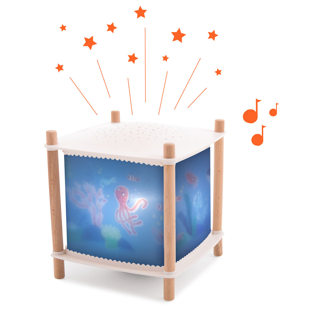 A colorful nightlight projector with wooden legs displays an underwater scene featuring octopuses and corals. Orange stars and music notes float above.