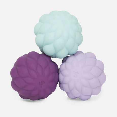 Three petal-textured silicone magnetic fidget spheres stacked in light blue, dark purple, and lavender.