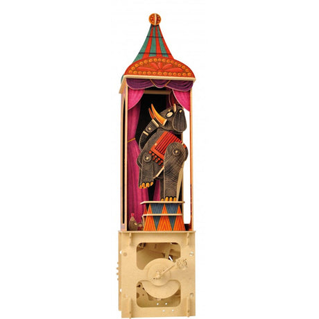 Whimsical elephant puppet in a colorful circus booth with red curtains and a striped canopy. The playful design evokes a joyful, nostalgic circus vibe.