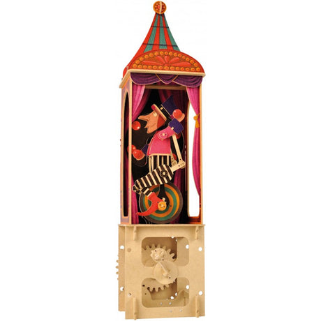 A colorful paper automaton depicts a clown juggling on a unicycle inside a circus-themed booth. The base shows visible gears, adding a playful tone.
