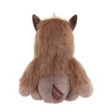 Back view of a sitting plush brown horned creature showing long fur on its head and back and a brand tag.