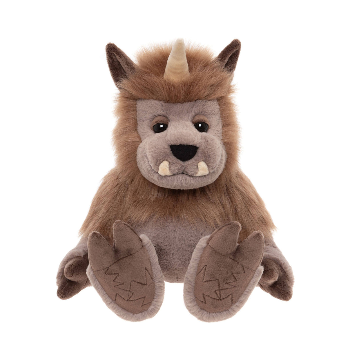Front view of a plush brown horned monster toy sitting with legs spread, small tusks, and patterned hooves.