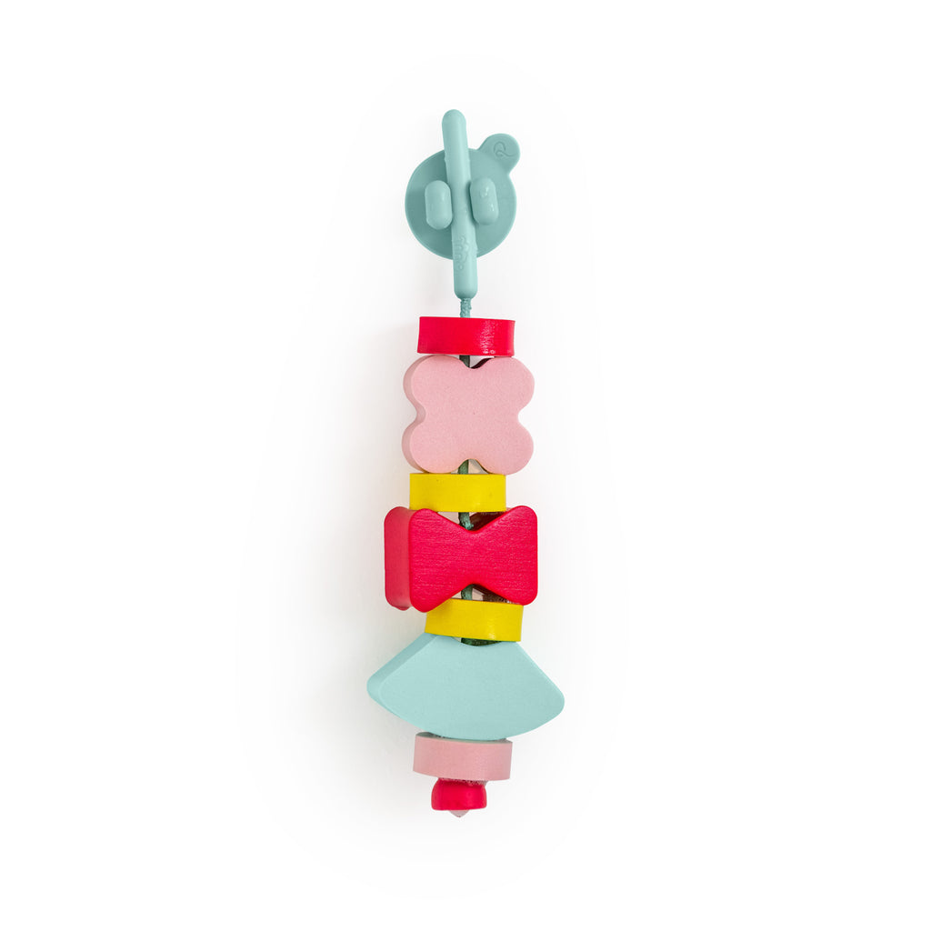 A colorful baby toy with various shaped beads; a blue suction cup on top, followed by pink, red, yellow, and aqua shapes, arranged vertically. Playful tone.