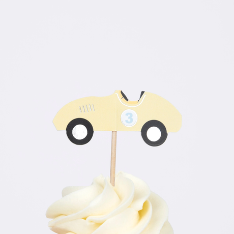 Yellow vintage race car cupcake topper with number three on a wooden pick in swirled frosting.