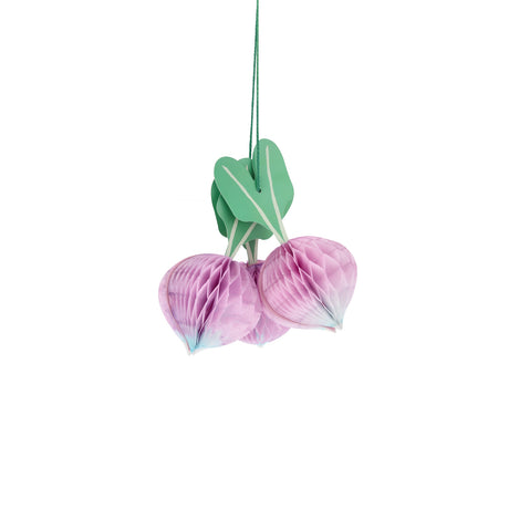 Three purple honeycomb paper radish decorations with green leaves hanging against a white background for party decor.