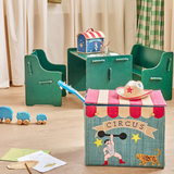 Children's playroom with circus-themed decor. A colorful toy chest, green chairs and table, toy elephants, and drawings create a whimsical, playful atmosphere.