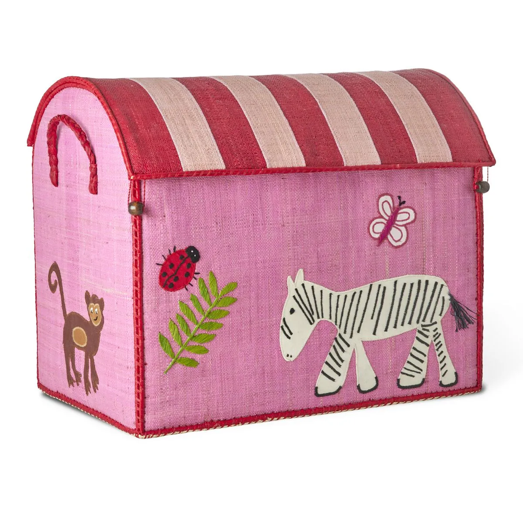 A pink, embroidered toy box with a striped lid features a zebra, monkey, ladybug, butterfly, and fern designs, conveying a playful, cheerful tone.