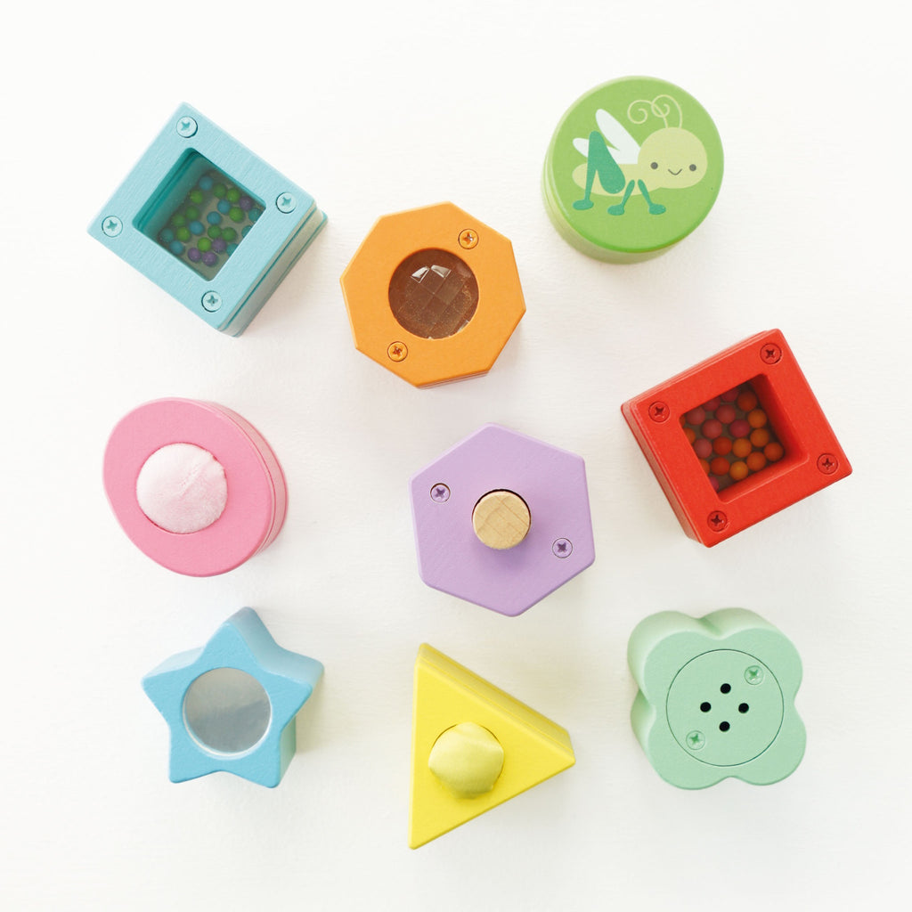 Colorful wooden shape sorting toy featuring various geometric shapes and cute animal designs on a light wood base.