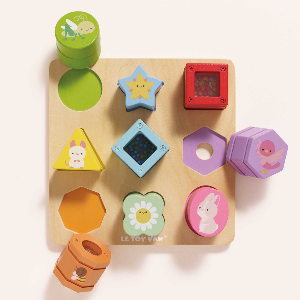 Colorful wooden shape sorting toy featuring various geometric shapes and cute animal designs on a light wood base.