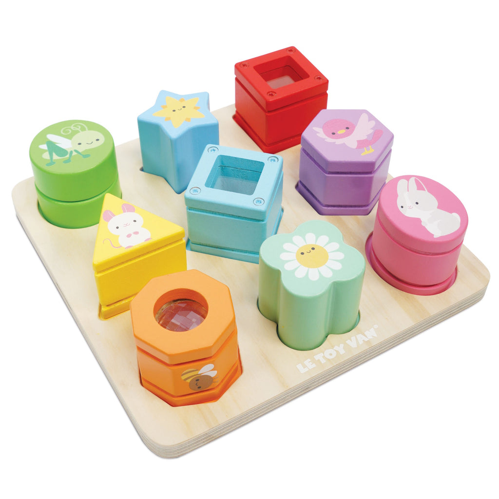 Colorful wooden shape sorting toy featuring various geometric shapes and cute animal designs on a light wood base.