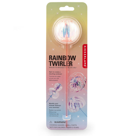 Packaging of Kikkerland's Rainbow Twirler toy. A clear ball on a stick with colorful spiral patterns, set against a pastel starry background.