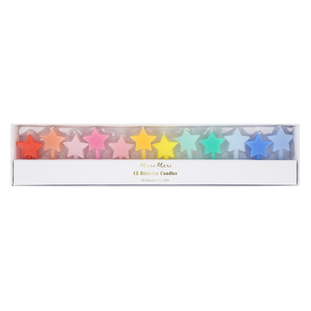 Boxed set of 12 Meri Meri star-shaped birthday candles arranged in a rainbow gradient.
