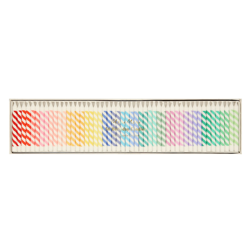 A box of 50 birthday candles in vibrant rainbow colors, arranged neatly. The candles have diagonal stripes, creating a festive and cheerful look.