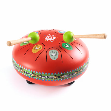 Red steel tongue drum with colorful geometric patterns and two green-tipped mallets for meditation and music.