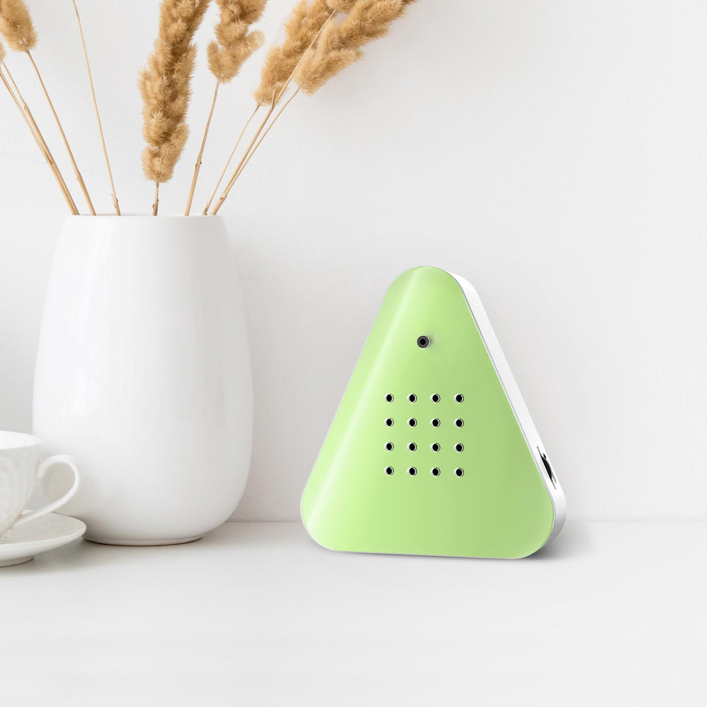 A triangular green device with a smooth surface, featuring a small camera and multiple circular holes on the front. It conveys a modern, minimalist design.