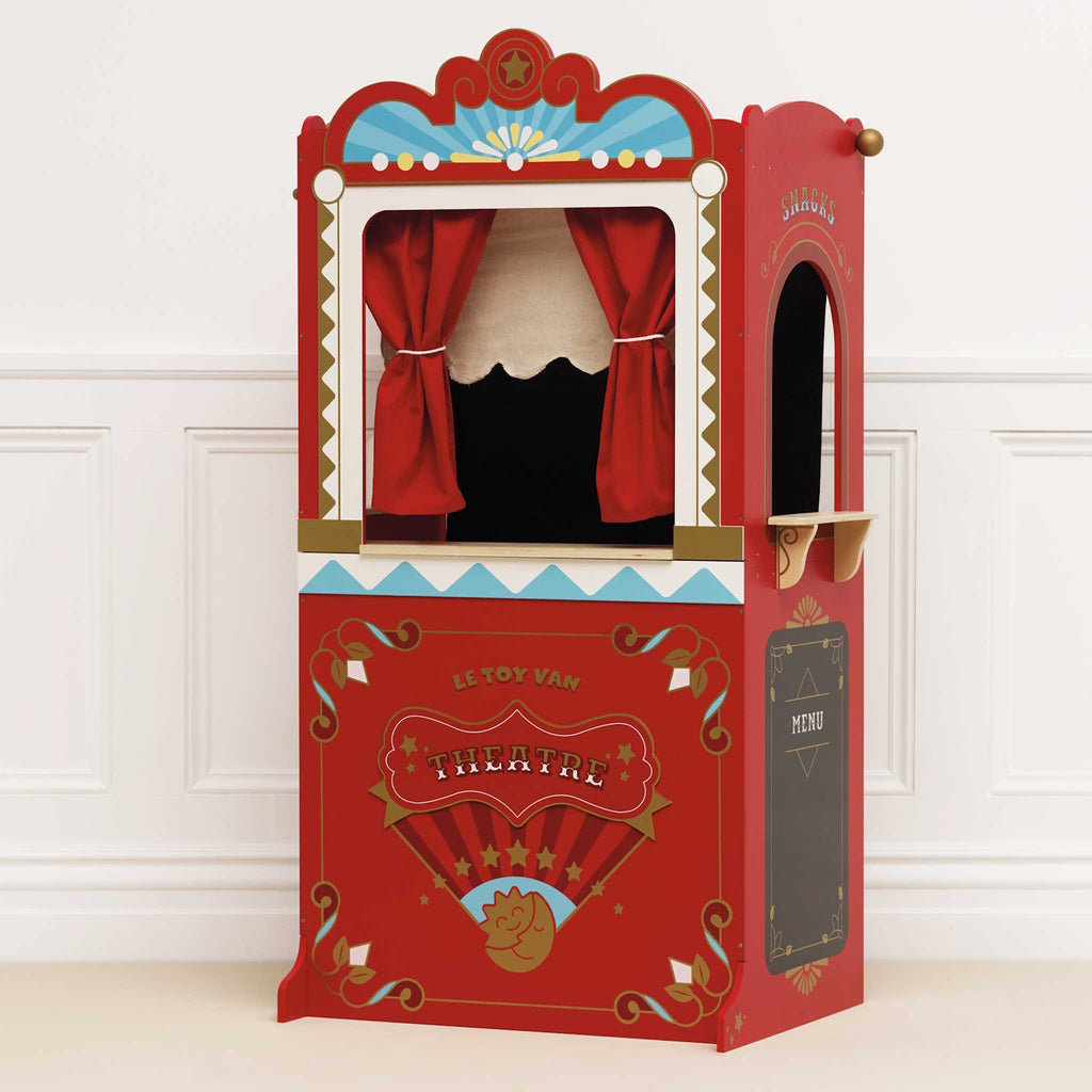 Red vintage-style puppet theater with a ticket booth. Features ornate decorations, star motifs, and red curtains. Charming, playful, and nostalgic.