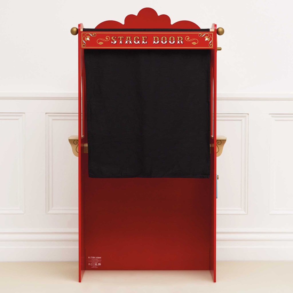 Red vintage-style puppet theater with a ticket booth. Features ornate decorations, star motifs, and red curtains. Charming, playful, and nostalgic.
