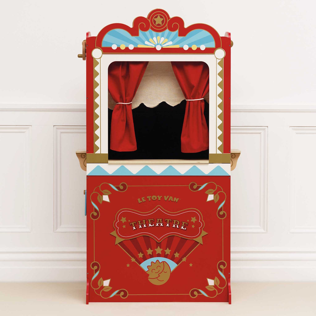 Red vintage-style puppet theater with a ticket booth. Features ornate decorations, star motifs, and red curtains. Charming, playful, and nostalgic.