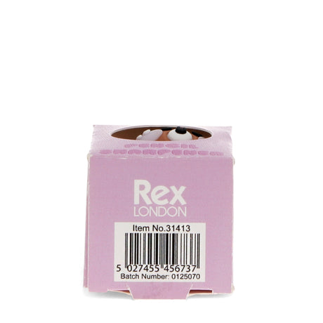 Pink box with "Rex London" branding, item number, and barcode. A cartoon dog's eyes peek out from the top, adding a playful touch.