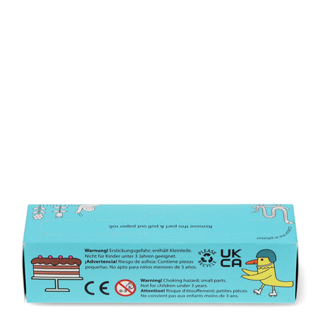 A light blue product box with illustrations of a cake and a duck wearing a helmet. Warning text in multiple languages mentions a choking hazard for children under 3, and recycling symbols are visible.