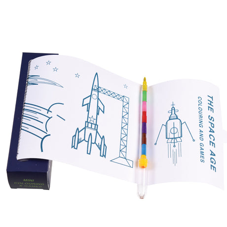 Open coloring book titled "The Space Age" features line drawings of rockets and stars. A colorful multi-tip pen is placed on the pages.