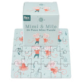 Puzzle featuring dancing mice in red outfits on a pale blue background. The box, labeled “Mimi & Milo,” showcases playful and joyful vibes.