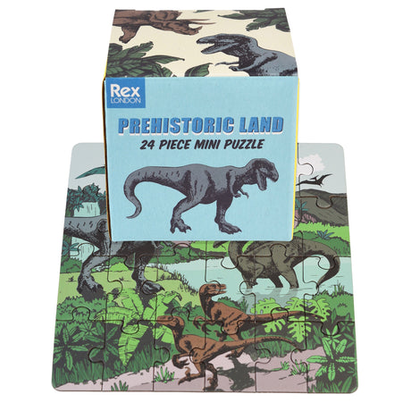 Rex London Prehistoric Land 24 piece mini puzzle box on top of the completed dinosaur-themed jigsaw puzzle.