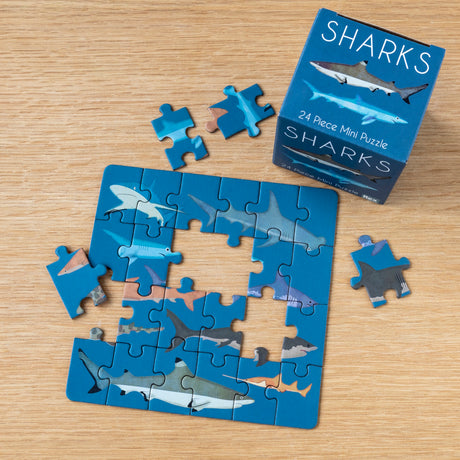 Rex London sharks 24-piece mini jigsaw puzzle with colorful illustrations and box on a wooden surface.