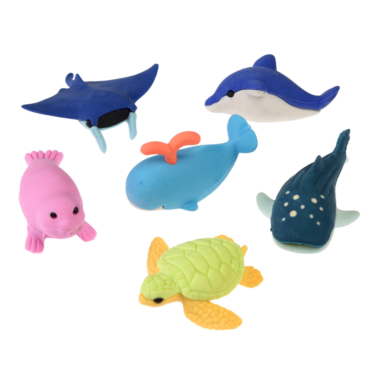 Toy sea animals arranged on a white background, including a blue dolphin, whale, manta ray, pink seal, green turtle, and a whale shark. Playful and colorful.