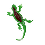 A green toy lizard with a shiny brown back and spread limbs lies isolated on a white background, resembling a playful and lifelike pose.