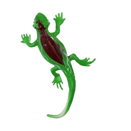 A green toy lizard with a shiny brown back and spread limbs lies isolated on a white background, resembling a playful and lifelike pose.