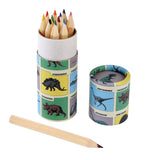 A cylindrical container with colorful dinosaur illustrations holds sharpened colored pencils. The matching lid is beside it, and a single pencil lies in front.