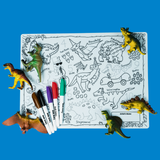 A dinosaur-themed coloring mat with plastic toy dinosaurs, markers, and line drawings of various dinosaurs.