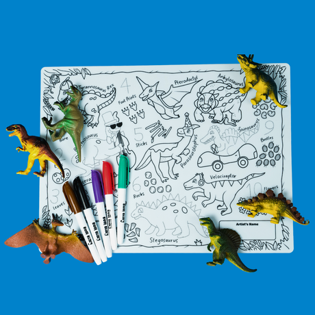 A dinosaur-themed coloring mat with plastic toy dinosaurs, markers, and line drawings of various dinosaurs.