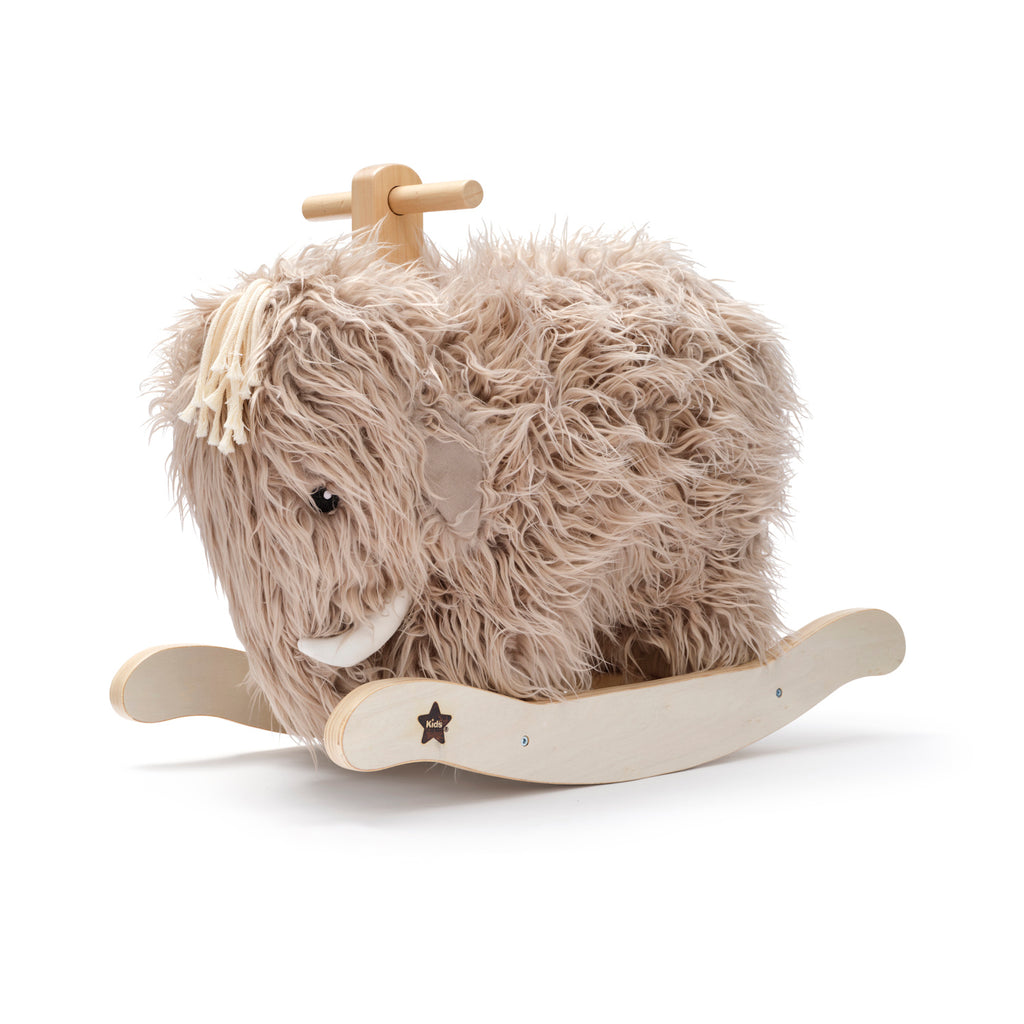 Fluffy mammoth rocking toy with beige fur, wooden handle, and curved wooden base, conveying a playful and cozy vibe.