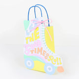 Retro roller skate gift bag with "Let the Good Times Roll" text, pastel colors, and pink ribbon bow.