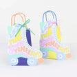 Retro roller skate gift bags with "Let the Good Times Roll" text, ideal for 70s disco or roller skating party favors.