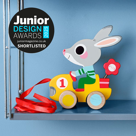 Wooden rabbit pull toy in a yellow car, shortlisted for the Junior Design Awards 2025.