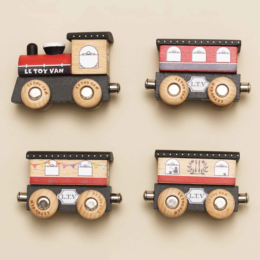 Wooden toy train with a red engine and three brown cars. Each car has detailed window decals and wooden wheels, evoking a playful, vintage charm.