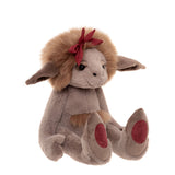 Plush creature with soft grey fur, fluffy brown mane, floppy ears, burgundy bow, and paw pads on a white background.