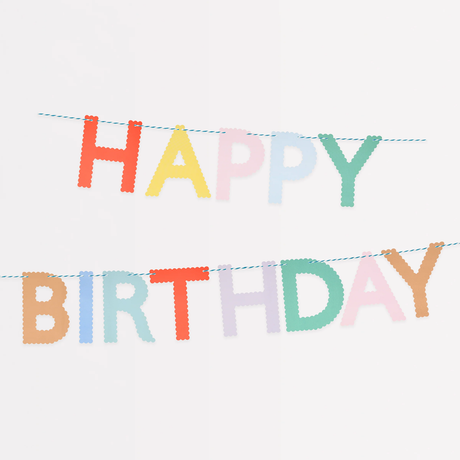 Two-tiered garland of pastel and bright scalloped paper letters spelling "HAPPY BIRTHDAY" on blue twine.