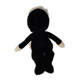 Back view of a plush blonde doll wearing a hooded black skeleton suit with arms outstretched.