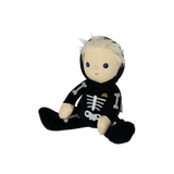 Three-quarter view of a seated plush blonde doll in a black skeleton suit with the hood down.