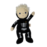 Plush blonde doll in a black skeleton suit with embroidered bones, raising one hand in a wave.