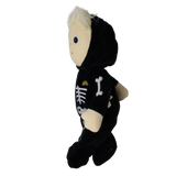 Side profile view of a plush blonde doll wearing a black skeleton suit.