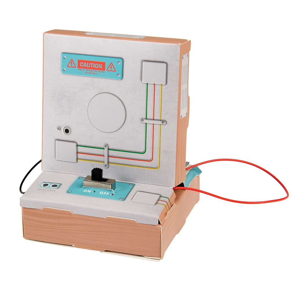 Cardboard model of a vintage computer with colored wiring diagram on its side. A black switch on the base shows "ON" and "OFF," with a red wire extending.