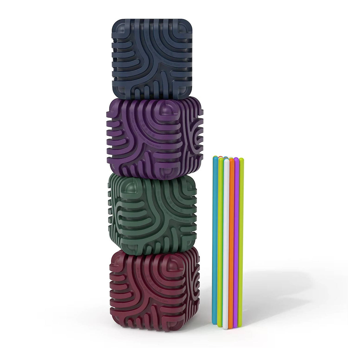 Four stacked sensory maze cubes in dark colors next to a row of colorful silicone sticks.