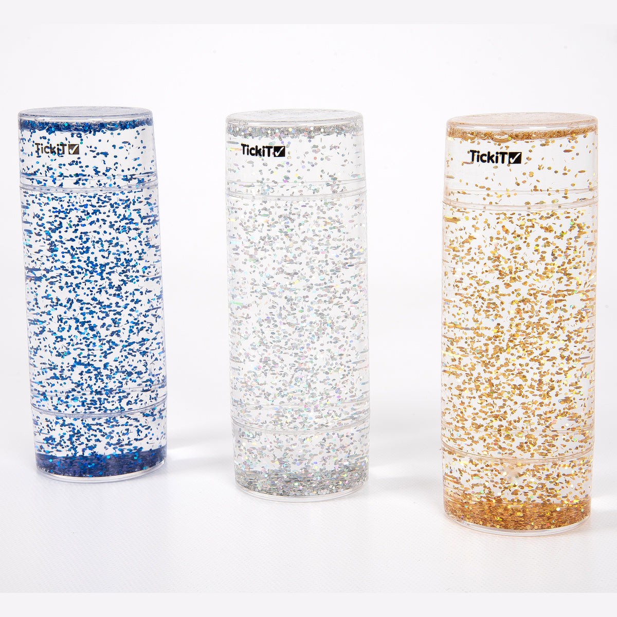 Three tall, clear cylinders filled with blue, silver, and gold glitter, set against a white background. Each has a black logo near the top.